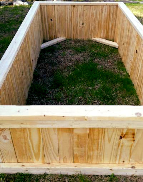 added trim and corner braces to raised bed garden