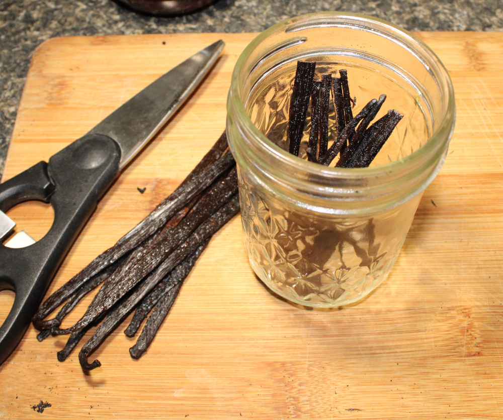 vanilla beans added to a jar for vanilla extract