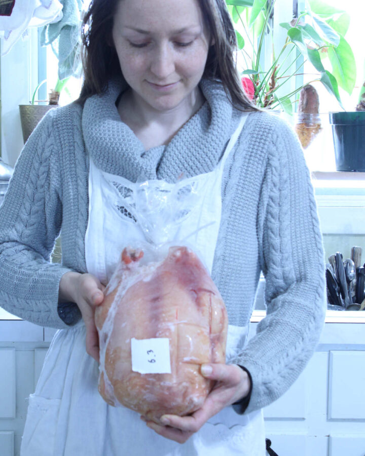 woman holding a home butchered packaged meat chicken
