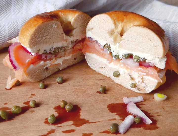 smoked salmon bagel sandwich sliced in half
