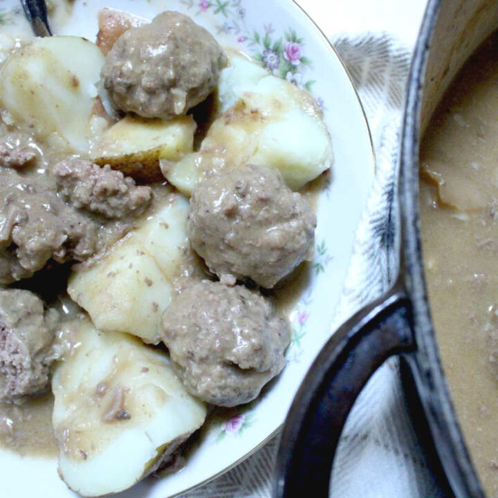 meatballs and potatoes in a bowl covered with gravy and a peek into the pot of the stew