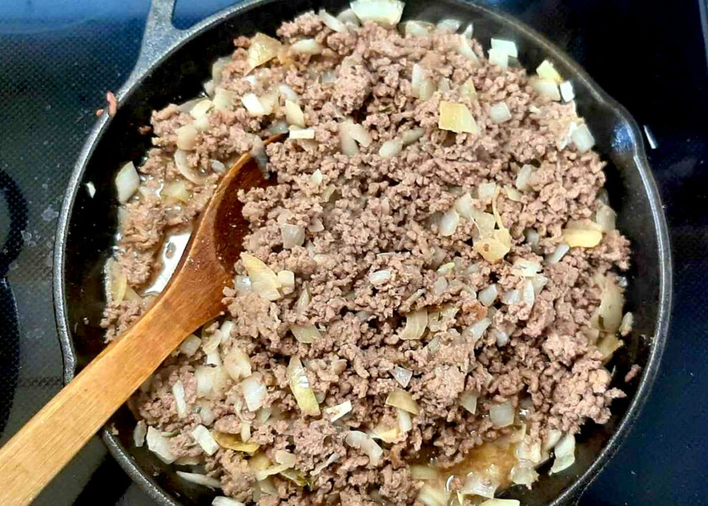 Chinese pie recipe cooking ground beef and onions in skillet