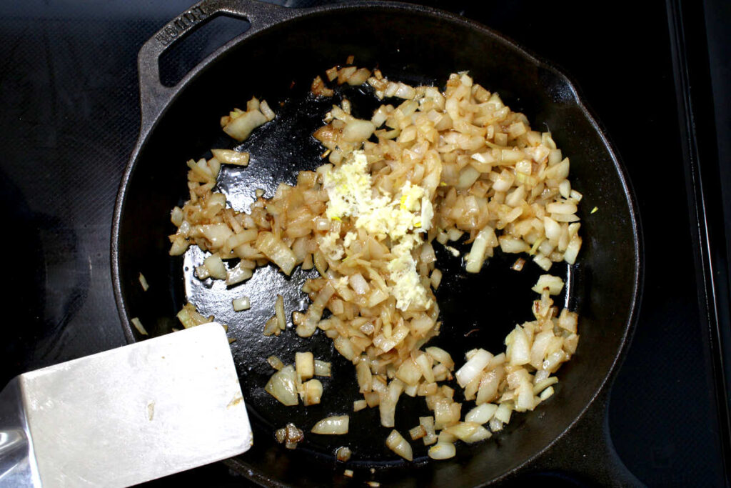 cooking onions and garlic in cast iron pan