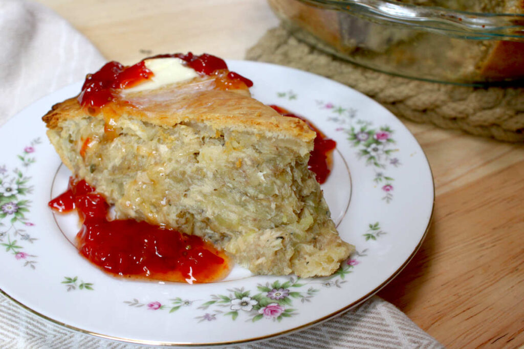 baked salmon pie slice with butter and sweet pepper relish on top