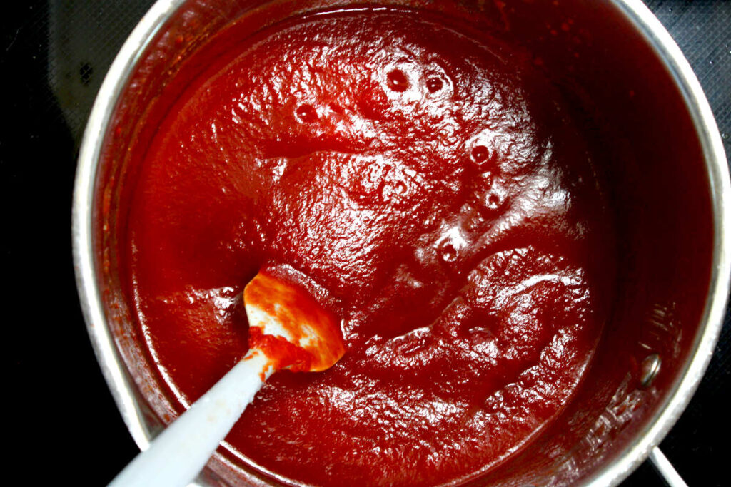 a pot on a stove of cooked sugar free ketchup